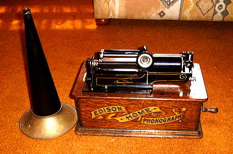 Edison Home phonograph with horn sitting at side.
